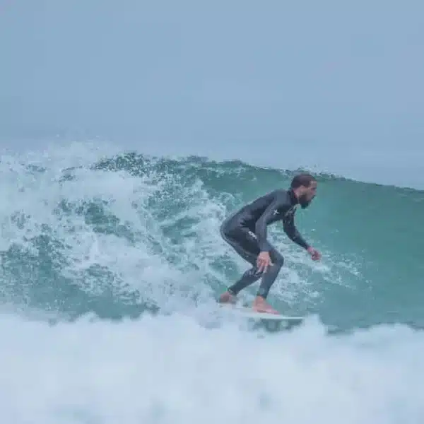 A tourist is surfing on wave in the city of Essaouira