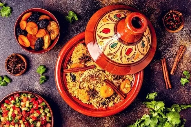 Moroccan food served in a traditional clay pot, showcasing vibrant colors and rich textures of the dish morocco desert tour