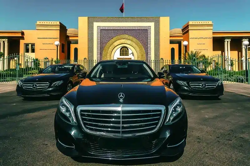 Several Mercedes-Benz S-Class vehicles parked outside a building, highlighting premium travel options with a Morocco private driver.