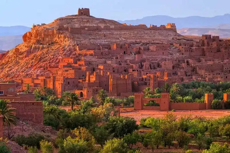 A panoramic view of the red city of Atad in Morocco, showcasing its vibrant architecture and surrounding landscape.