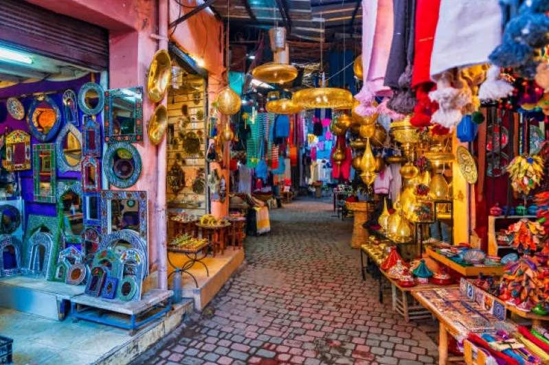 A vibrant Moroccan souk filled with an array of colorful items, showcasing the rich culture and lively atmosphere of the market.