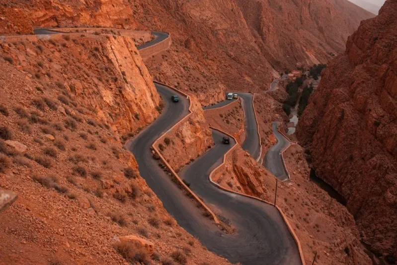 A scenic view of a winding mountain road in Morocco, perfect for quad biking adventures amidst stunning landscapes.