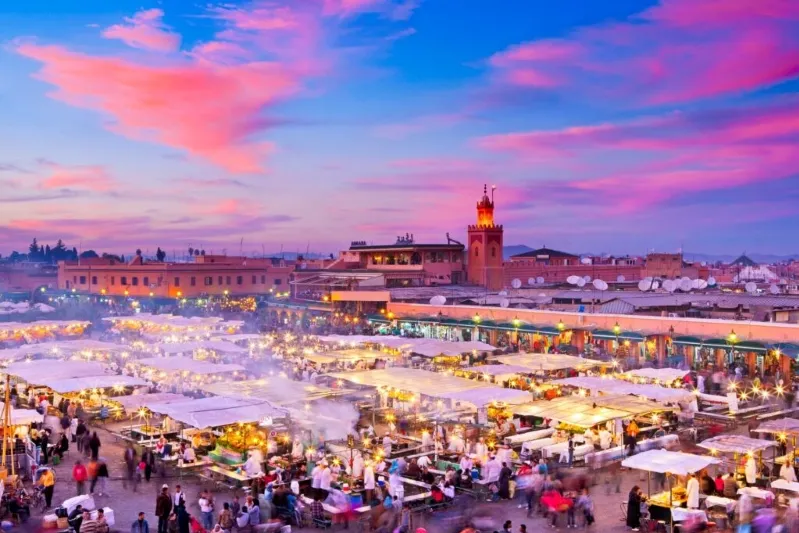 The city of Marrakech at sunset, showcasing its rich culture and the lively spirit of Moroccan festivals.