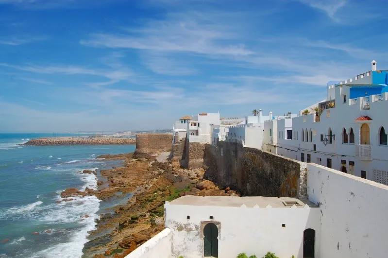 A panoramic view of the sea and white buildings from a hilltop, capturing the essence of Morocco beach holidays.
