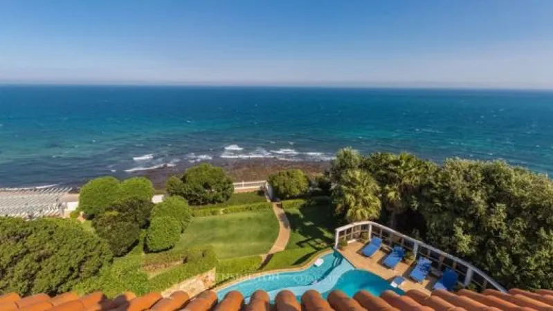 The ocean stretches out from the villa's rooftop, offering a stunning vista of Tangier's serene coastline. 