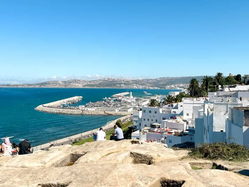 A panoramic view from a hilltop in Tangier, showcasing the vast sea and the horizon beyond.