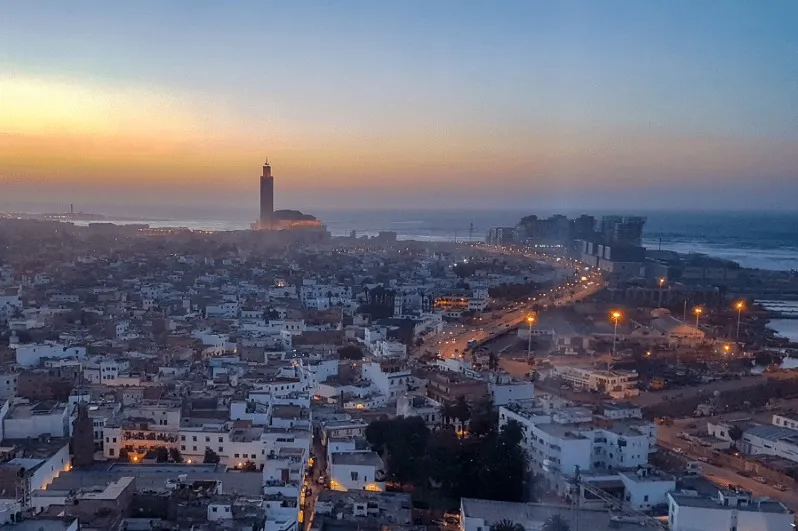 The city of Casablanca bathed in sunset hues, highlighting its beauty and allure for those travel to tangier.