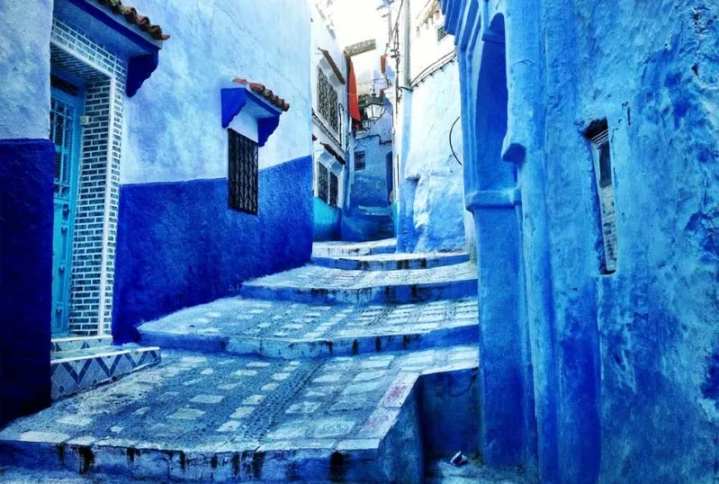 A scenic view of Chefchaouen, Morocco, showcasing its iconic blue buildings and vibrant streets, perfect for sightseeing.