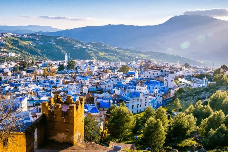 A panoramic view of Chefchaouen, Morocco, showcasing its iconic blue buildings and vibrant cultural attractions. 