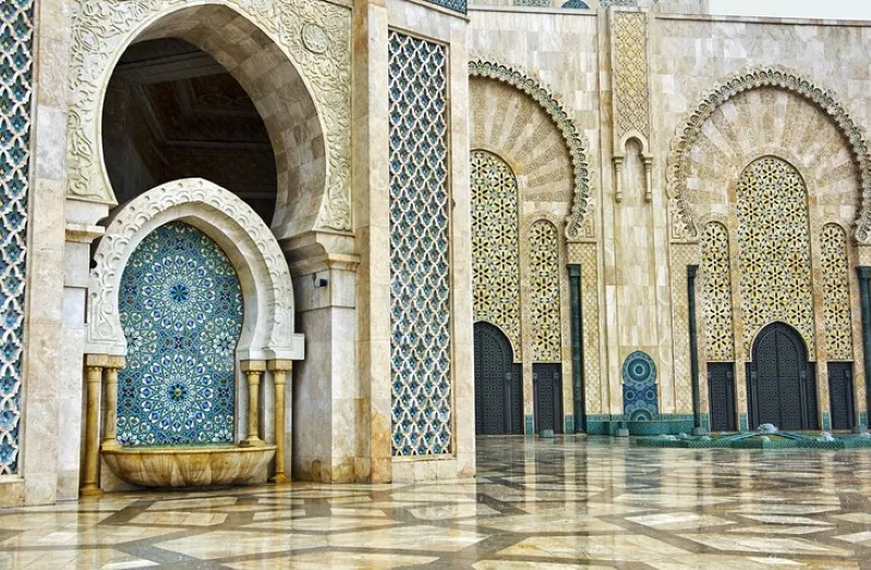 Interior view of a mosque in Casablanca featuring elegant arches and a serene fountain at its center. 