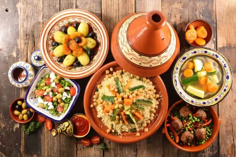 A beautifully arranged table featuring various dishes from a marrakech cooking class family. 
