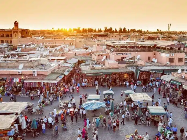  A stunning sunset over Marrakech, showcasing the city's vibrant colors and unique architecture, Is It Safe to Travel to Morocco.
