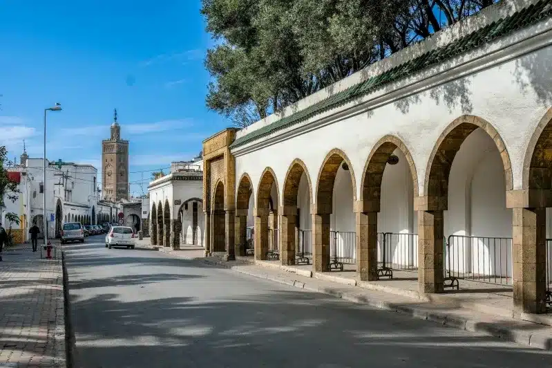 A street in Casablanca featuring elegant arches and buildings, showcasing the city's unique architectural style.