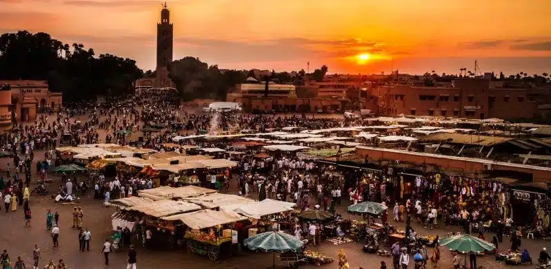 A stunning sunset casts vibrant hues over the city of Marrakesh, Morocco North Africa highlighting its unique architecture and landscape.