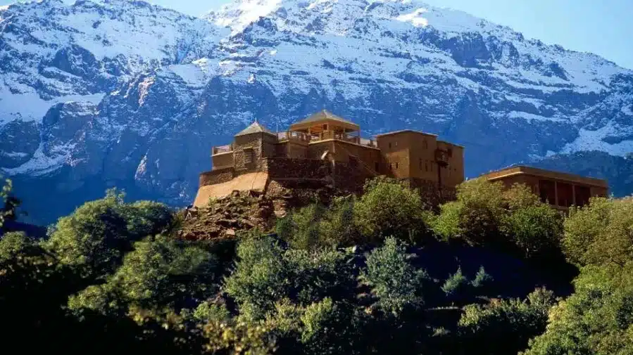 A majestic castle atop a mountain, surrounded by snow-capped peaks in Morocco, North Africa.