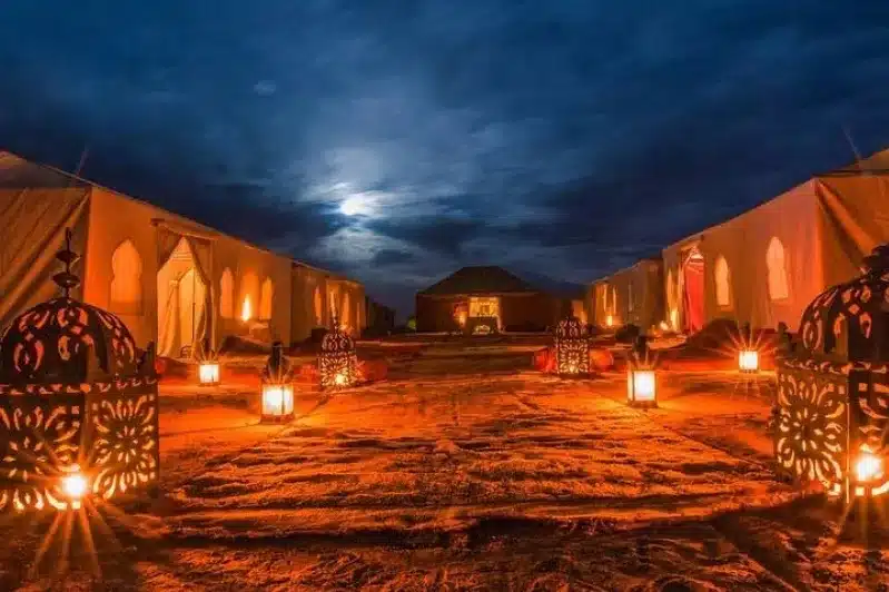 The moonlight filters through tents at night, enhancing the experience of a 10-day tour in Morocco from Casablanca.