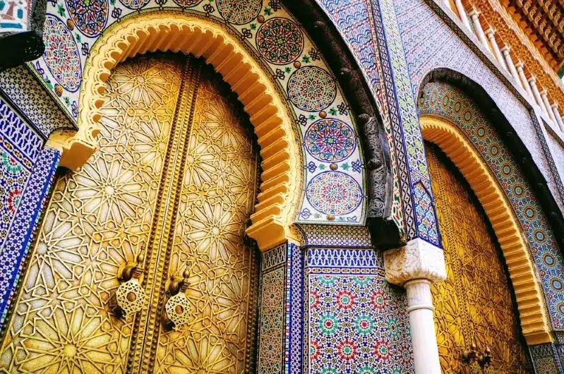 Golden mosque doors in Morocco, intricately designed, reflecting the rich culture and heritage of Moroccan architecture.