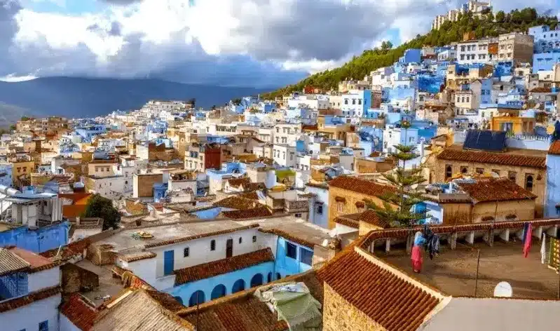 Scenic view of Chefchaouen, Morocco, showcasing its iconic blue buildings and mountainous backdrop, a top travel destination.