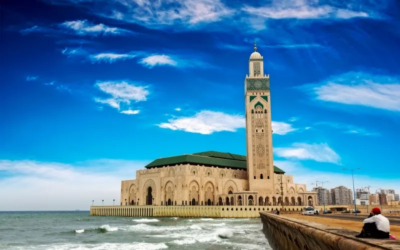 The grand mosque of Casablanca, Morocco, beautifully illuminated for New Year's celebrations, showcasing its stunning architecture.
