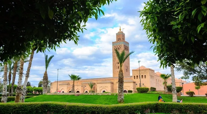 A stunning view of the Marrakech mosque illuminated for new year's eve marrakech celebrations in Morocco, showcasing its architectural beauty.