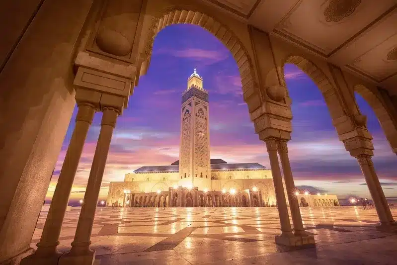 A mosque illuminated by sunset, showcasing its architectural beauty, a must-visit site in Morocco.