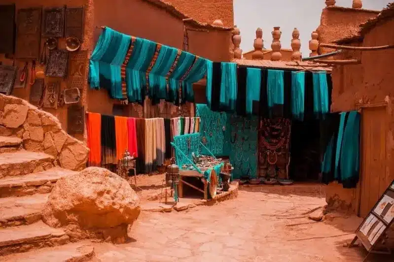 A picturesque village in Morocco featuring vibrant clothes hanging on walls, showcasing local culture and charm.