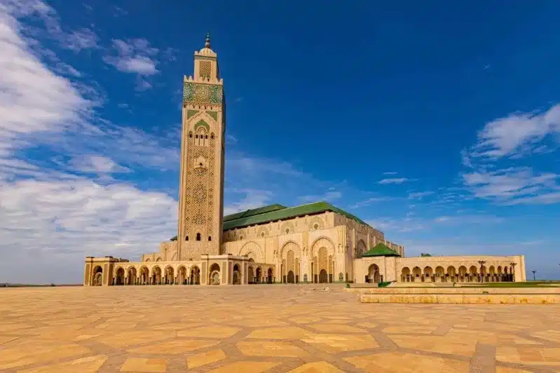 The Hassan II Mosque in Casablanca, Morocco, showcasing its stunning architecture against a clear blue sky.