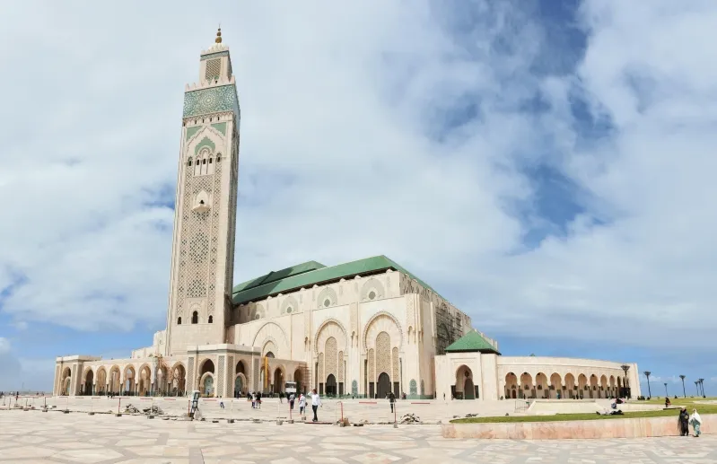 The Hassan II Mosque in Casablanca, Morocco, showcasing its stunning architecture against a clear blue sky.