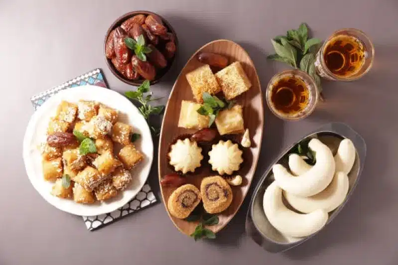  A Moroccan dessert featuring an assortment of dates and nuts, beautifully arranged on a traditional plate.