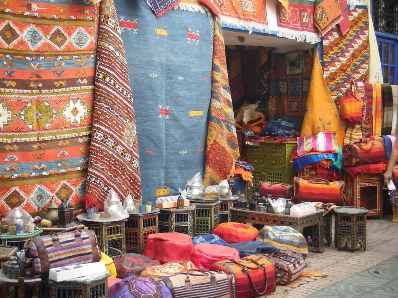 A vibrant rug lies on the ground, enhancing the serene atmosphere of a yoga marrakech.