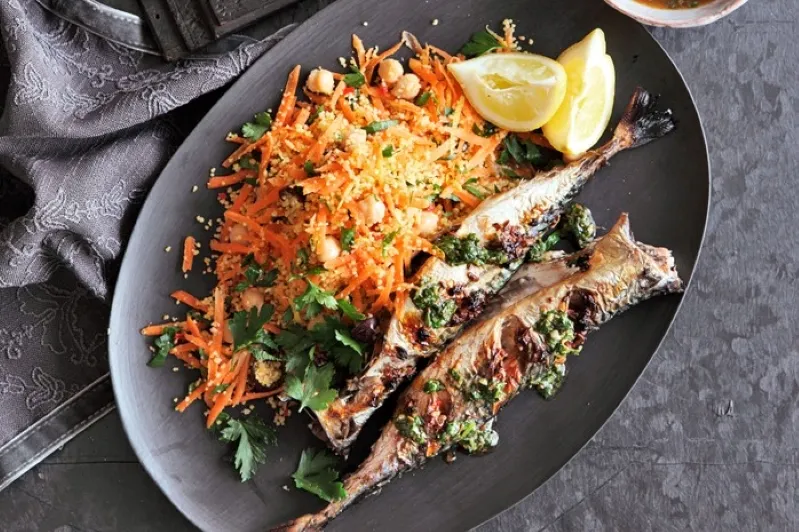 Grilled sardines served with couscous and parsley, showcasing the essence of the best Moroccan cuisine.