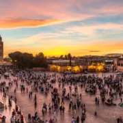 A vibrant sunset over Marrakech, Morocco, showcasing the city's skyline and warm hues, highlighting its beauty as a travel destination.
