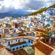 Scenic view of Chefchaouen, Morocco, showcasing its iconic blue buildings and mountainous backdrop, ideal for travel in spring.
