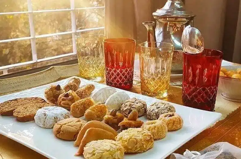 A tray of Moroccan sweets and tea elegantly arranged on a table, inviting and delightful for a cozy gathering.