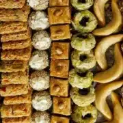 An elegant tray displaying a selection of Moroccan desserts, including cookies and pastries in diverse styles and flavors.