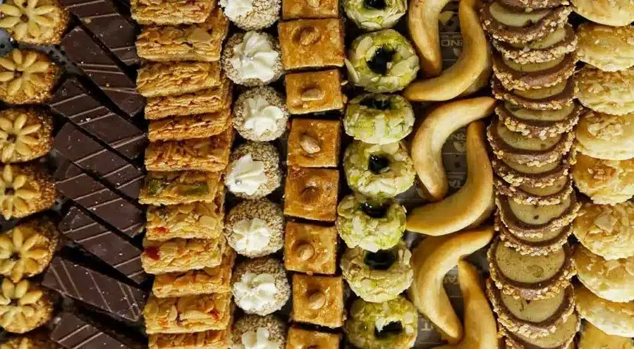 An elegant tray displaying a selection of Moroccan desserts, including cookies and pastries in diverse styles and flavors.