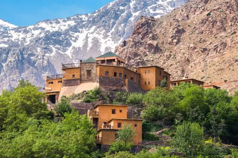 A charming mountain village set against a backdrop of a breathtaking mountain range, ideal for an all-inclusive Morocco vacation.