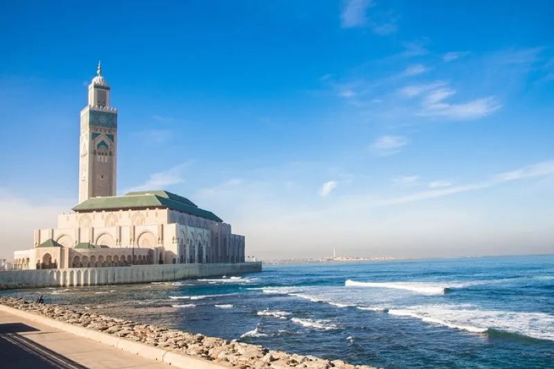 The Hassan II Mosque in Casablanca, Morocco, showcasing its stunning architecture against a clear blue sky. 