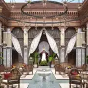 The lobby of a luxury hotel in Morocco features ornate furniture and elegant decor, showcasing opulence and sophistication.