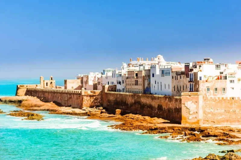 showcasing its vibrant architecture and bustling streets under a clear blue sky. 