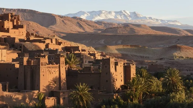 A panoramic view of the city of Atlas in Morocco, showcasing its unique architecture and surrounding mountainous landscape.