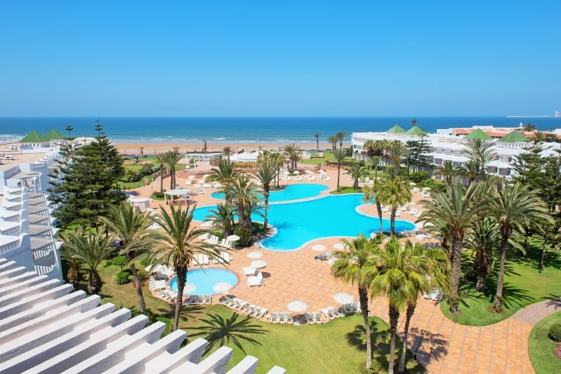 A panoramic view of the pool and beach from the hotel rooftop, showcasing the beauty of an all-inclusive Morocco vacation.