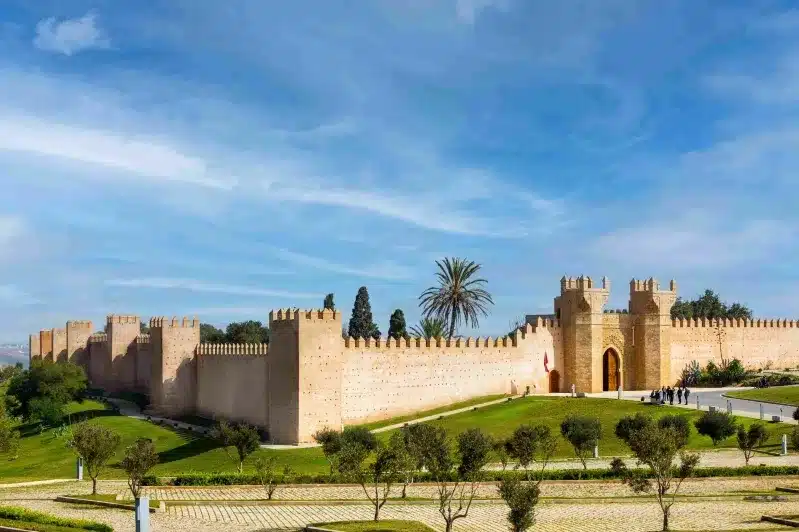 A majestic Moroccan castle, showcasing traditional Amazigh architecture against a clear blue sky. 
