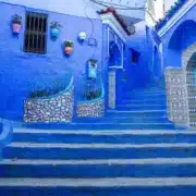 Scenic view of Chefchaouen, Morocco, showcasing its iconic blue buildings and mountainous backdrop, ideal for senior tours.