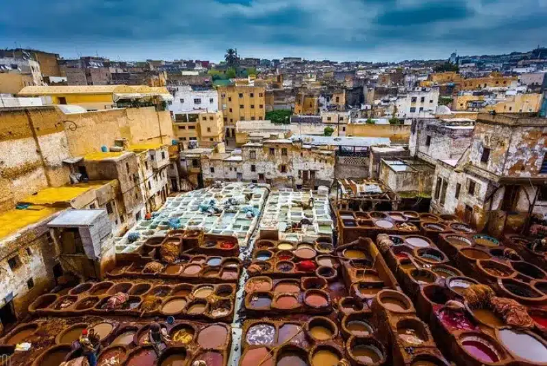Colorful pots line the streets of a Morocco Travel Agent, showcasing vibrant local craftsmanship and culture.