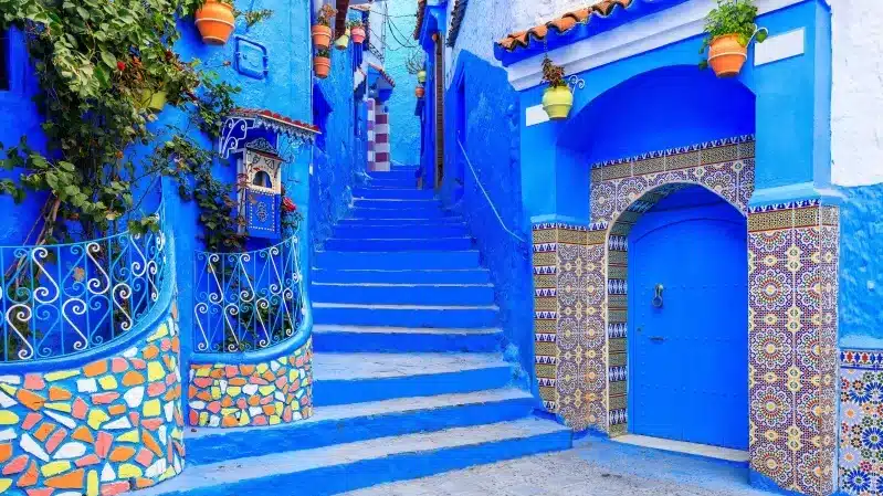 Scenic view of Chefchaouen, Morocco, showcasing its iconic blue buildings and mountainous backdrop.