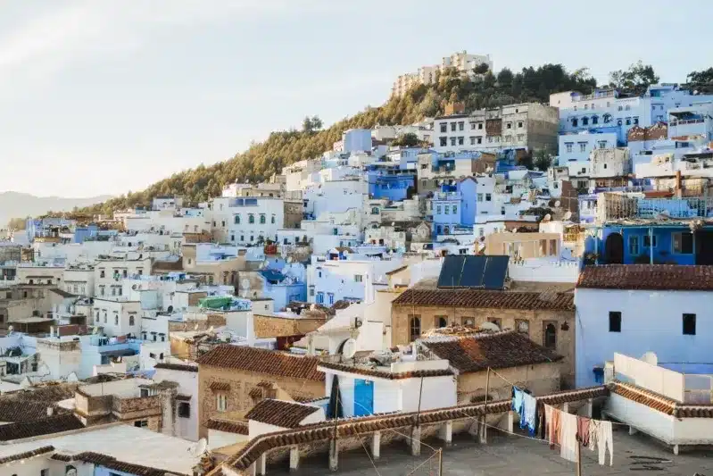 Scenic view of Chefchaouen, Morocco, showcasing its iconic blue buildings and mountainous backdrop. A must-visit destination. 