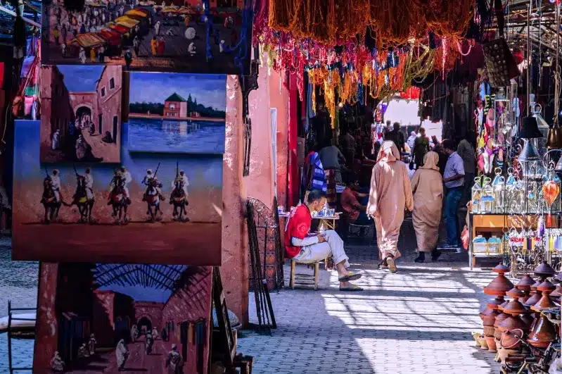  A vibrant visit Morocco market filled with colorful goods and people exploring the lively atmosphere. 