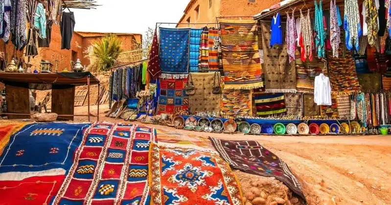 Vibrant Moroccan market with colorful carpets and rugs, highlighting the importance of morocco safety for women.