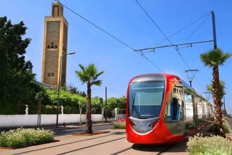 A red and white train traveling along the tracks, symbolizing Morocco tours from Casablanca.